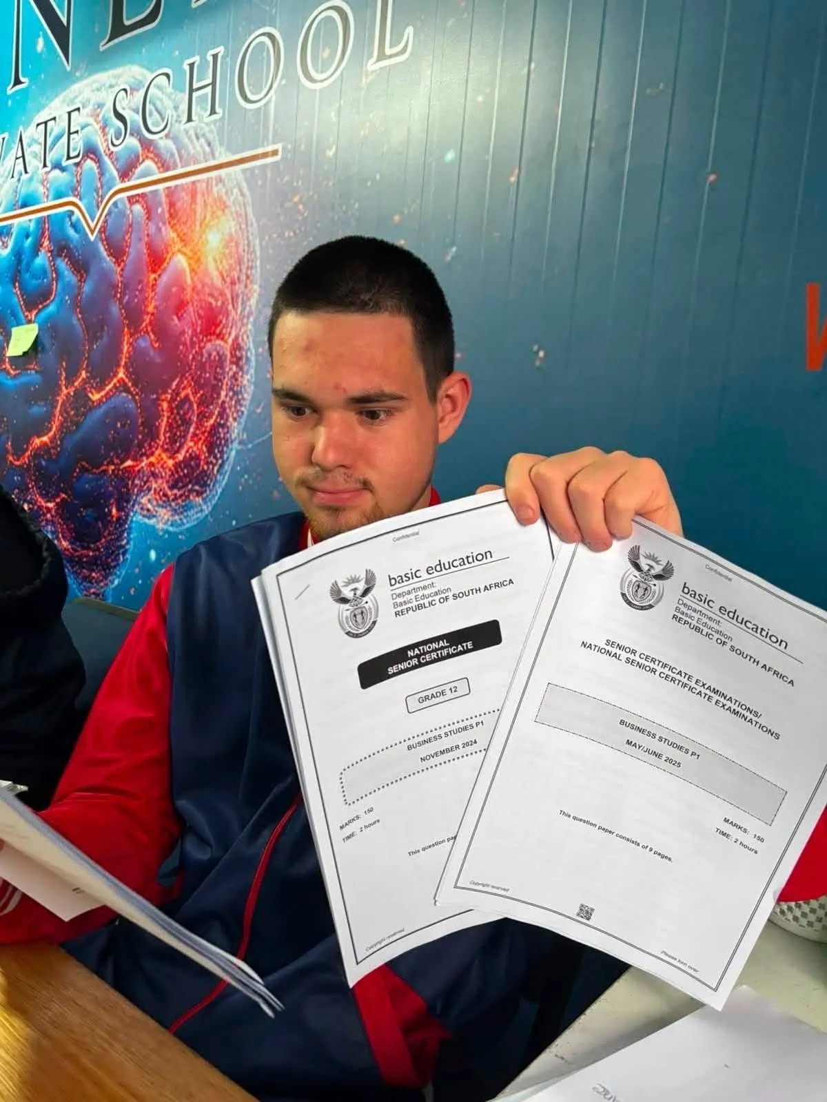 Grade 12 Soneike learner reviewing NSC Business Studies exam papers