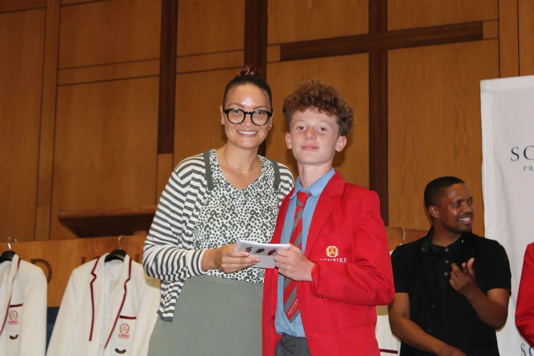 Soneike STEM School Term 1 awards — learner and staff member holding award