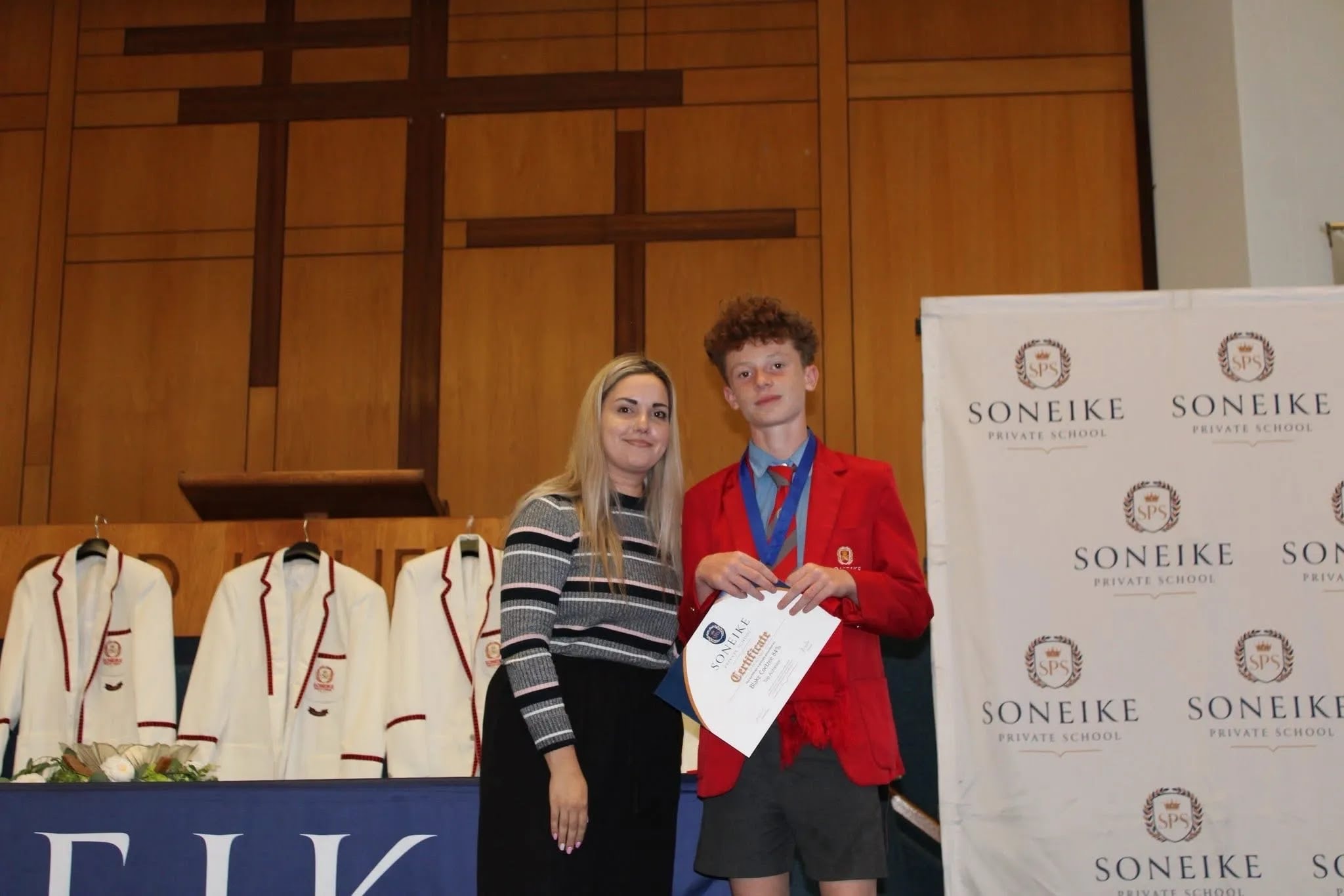 Soneike STEM School Term 1 awards — proud learner on stage